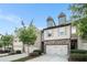 Charming townhome with stone accents, a two-car garage, and well-maintained landscaping at 2909 Emme Ct, Conyers, GA 30094