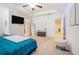 Bright main bedroom features a tray ceiling, ceiling fan, and walk-in closet at 2909 Emme Ct, Conyers, GA 30094