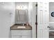 Bathroom vanity with a granite countertop, framed mirror and modern lighting at 3190 Water Brook Sw Dr, Conyers, GA 30094
