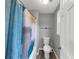 Bathroom with toilet and a tub and shower with a curtain and a white door at 3190 Water Brook Sw Dr, Conyers, GA 30094