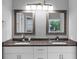 Bathroom with double sinks, granite counters and modern lighting at 3190 Water Brook Sw Dr, Conyers, GA 30094