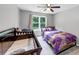 Bedroom featuring a bed, crib and a large window at 3190 Water Brook Sw Dr, Conyers, GA 30094