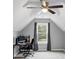 Neutral bedroom with ceiling fan, window, and desk and chair at 3190 Water Brook Sw Dr, Conyers, GA 30094