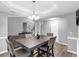 An elegant dining room with natural light, chandelier, table, and seamless flow to the cozy living spaces at 3190 Water Brook Sw Dr, Conyers, GA 30094