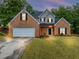 Charming two-story brick home with manicured lawn and attached two-car garage at 3190 Water Brook Sw Dr, Conyers, GA 30094
