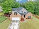 Beautifully landscaped brick home featuring a manicured front yard and an attached two car garage at 3190 Water Brook Sw Dr, Conyers, GA 30094