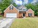Well-maintained two-story brick home featuring an attached two-car garage at 3190 Water Brook Sw Dr, Conyers, GA 30094