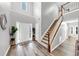Bright foyer featuring hardwood floors, a staircase, and a soaring ceiling at 3190 Water Brook Sw Dr, Conyers, GA 30094