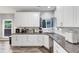 Modern kitchen featuring granite countertops, white cabinets, stainless steel appliances, and ample counter space at 3190 Water Brook Sw Dr, Conyers, GA 30094