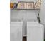 Neat laundry room with washer, dryer and shelf for supplies at 3190 Water Brook Sw Dr, Conyers, GA 30094