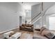 Spacious living room with staircase and a large window that floods the space with natural light at 3190 Water Brook Sw Dr, Conyers, GA 30094