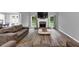 Cozy living room with hardwood floors, fireplace, and plenty of natural light at 3190 Water Brook Sw Dr, Conyers, GA 30094