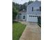 Charming two-story home with blue siding, white trim, and an attached garage at 4965 N Bridges Dr, Alpharetta, GA 30022