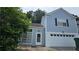 Charming two-story home with blue siding, white trim, and an attached garage at 4965 N Bridges Dr, Alpharetta, GA 30022