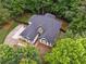 Aerial shot showcases the home with its driveway, luscious landscaping, and surrounding trees at 827 Holly Rdg, Canton, GA 30115