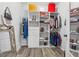 Organized walk-in closet with shelving, hanging rods, drawers, and luxury brand shopping bags at 827 Holly Rdg, Canton, GA 30115