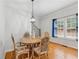 Bright dining room with hardwood floors, natural light, decorative light fixture and staircase at 827 Holly Rdg, Canton, GA 30115