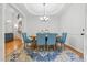 Dining room featuring a chandelier, hardwood floors, blue chairs, and natural light at 827 Holly Rdg, Canton, GA 30115