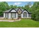 Charming two-story home with black and white trim, stone accents, and a lush green lawn at 827 Holly Rdg, Canton, GA 30115