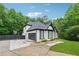 Exterior of the home, driveway, lawn, and basketball hoop in wooded surroundings at 827 Holly Rdg, Canton, GA 30115