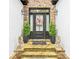 Welcoming front entrance with stone accents, potted plants, and a decorative wreath at 827 Holly Rdg, Canton, GA 30115