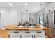 Open kitchen with stainless appliances and an island that features a gas stovetop with white cabinets at 827 Holly Rdg, Canton, GA 30115
