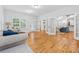 Open concept living room with hardwood floors, white trim and lots of natural light at 827 Holly Rdg, Canton, GA 30115
