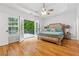 Main bedroom boasting hardwood floors, ceiling fan, and French doors leading to the exterior deck at 827 Holly Rdg, Canton, GA 30115