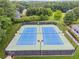 Aerial shot of the tennis courts, with their blue and green paint, and a white clubhouse at 827 Holly Rdg, Canton, GA 30115