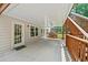 Back porch featuring a wooden swing, wooden railing, and access to the backyard at 1275 Kelly Nelson Dr, Lawrenceville, GA 30043