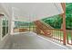 Back porch featuring a wooden swing, wooden railing, and access to the backyard at 1275 Kelly Nelson Dr, Lawrenceville, GA 30043
