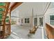 Covered back porch featuring a wooden swing, ceiling, wooden beams, and access to the backyard at 1275 Kelly Nelson Dr, Lawrenceville, GA 30043