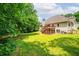Backyard with a two story deck and stairs leading down to a well maintained grassy area at 1275 Kelly Nelson Dr, Lawrenceville, GA 30043
