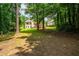 View of the backyard featuring the two story deck and a wooded area behind the home at 1275 Kelly Nelson Dr, Lawrenceville, GA 30043