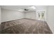 Spacious basement featuring neutral carpeting, ceiling fan, and a double door leading to the outdoors at 1275 Kelly Nelson Dr, Lawrenceville, GA 30043