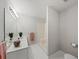 Bathroom featuring white cabinets, a large mirror with lights, and a shower with a white surround at 1275 Kelly Nelson Dr, Lawrenceville, GA 30043