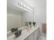 Bathroom featuring white cabinets, a large mirror with lights, and a shower with a white surround at 1275 Kelly Nelson Dr, Lawrenceville, GA 30043