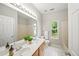 Bathroom with a double sink vanity, large mirror, tub and a window for natural light at 1275 Kelly Nelson Dr, Lawrenceville, GA 30043