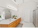 Bright bathroom featuring a double vanity, ample counter space, and a large mirror with vanity lighting at 1275 Kelly Nelson Dr, Lawrenceville, GA 30043