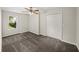 Bright bedroom featuring neutral walls, a window with outdoor views, a ceiling fan, and a closet at 1275 Kelly Nelson Dr, Lawrenceville, GA 30043