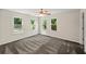 Bright bedroom featuring neutral walls, large windows with green outdoor views, and a ceiling fan at 1275 Kelly Nelson Dr, Lawrenceville, GA 30043