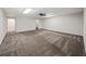 Large bonus room with neutral walls, gray carpeting, and ceiling fan for comfort at 1275 Kelly Nelson Dr, Lawrenceville, GA 30043