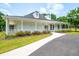 Community clubhouse featuring white columns, a covered porch, and a well-manicured lawn at 1275 Kelly Nelson Dr, Lawrenceville, GA 30043