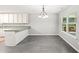 Sunlit dining area with tile floors, chandelier, and view to outdoor patio at 1275 Kelly Nelson Dr, Lawrenceville, GA 30043