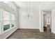 Bright dining room featuring neutral paint, wood-look floors, and modern light fixture at 1275 Kelly Nelson Dr, Lawrenceville, GA 30043