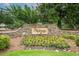 Stone entrance to the Hadaway community with lush landscaping and flowering plants at 1275 Kelly Nelson Dr, Lawrenceville, GA 30043