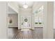 Bright foyer featuring wood-look floors, a statement light fixture and front door with glass sidelights at 1275 Kelly Nelson Dr, Lawrenceville, GA 30043
