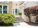 Inviting front entrance with stone steps leading to the glass front door at 1275 Kelly Nelson Dr, Lawrenceville, GA 30043