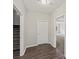 Hallway with hardwood-style floors, connecting to stairs and an adjacent room with carpet at 1275 Kelly Nelson Dr, Lawrenceville, GA 30043