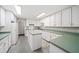 Bright kitchen featuring ample white cabinetry, green countertops, and tile floors at 1275 Kelly Nelson Dr, Lawrenceville, GA 30043
